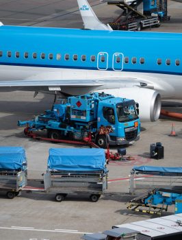 Close-up of KLM aircraft during ground handling operations at an airport.