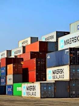 Colorful stacked shipping containers at a port exemplify global logistics.